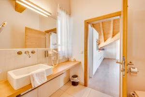 a bathroom with a sink and a mirror at Chalet Bergliebe zentral mit Bergblick in Seefeld in Tirol