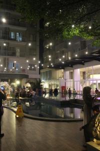 a group of people in a building at night at Apartement Bogor Icon Syariah, View Gunung Salak in Bogor