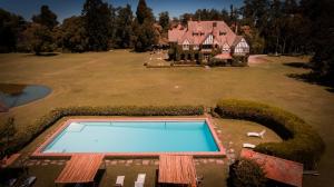 an aerial view of a large house with a swimming pool at Estancia Villa Maria in Ezeiza
