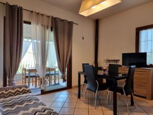 a dining room with a table and chairs and a television at Leo's House - BUDONI SWEET HOME in Budoni