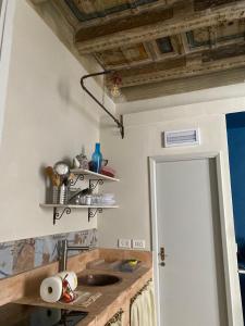 a kitchen with a sink and a wooden ceiling at La Dimora di Corso Marconi in Fermo +14 photos
