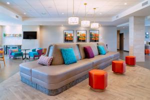 a couch with colorful pillows sitting in a lobby at Home2 Suites By Hilton Lake Havasu City in Lake Havasu City