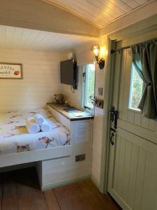a small bedroom with a bed and a sink at Apple Hut in Torquay