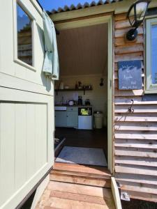 an open door to a kitchen in a garage at Apple Hut in Torquay