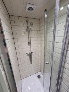 a shower with a glass door in a bathroom at Apple Hut in Torquay +37 photos