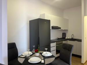 a kitchen with a table and two chairs and a refrigerator at Calypso in Trogir