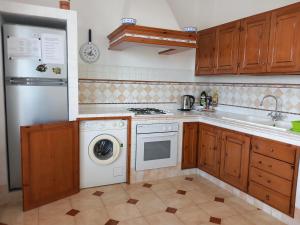een keuken met een wasmachine en een vaatwasser bij Villetta Panoramica in Ischia