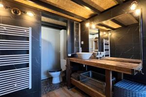 a bathroom with a wooden counter and a sink at LOFT - Jardin des Plantes in Rouen