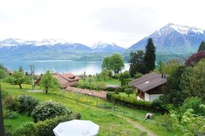 a house with a view of a lake and mountains at B&B Schönörtli in Gunten