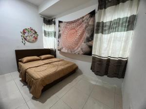 a small bedroom with a bed and a window at idaman hill homestay in Ipoh +25 photos