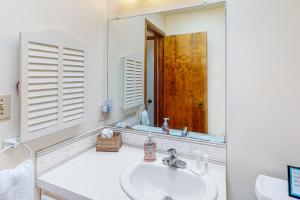 a bathroom with a sink and a large mirror at Friend-Ship in Rockaway Beach +22 photos