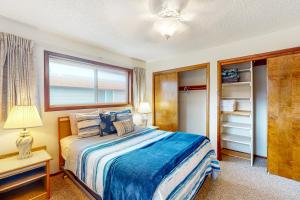 a bedroom with a large bed and a window at Friend-Ship in Rockaway Beach
