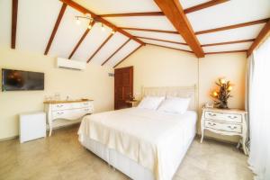 a bedroom with a white bed and a sink at Yalicapkini Boutique Hotel in Gulluk