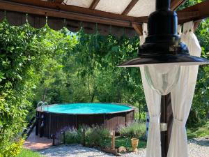 a hot tub in a backyard with a pergola at Il Nascondiglio - The Hideaway in Amandola