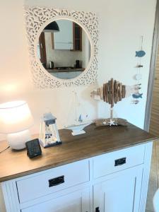 a white dresser with a mirror on the wall at Casa Vittorina in Pula