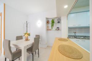 a kitchen and dining room with a table and chairs at HomeHolidaysRentals Caliz - Costa Barcelona in Pineda de Mar