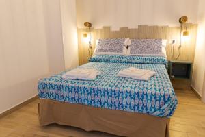 um quarto com uma cama grande e toalhas em Sea Garden Apartments em Ascea