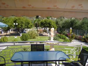 a blue table and a fountain in a park at Elisabeth Villas in Kerveli