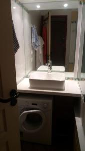 a bathroom with a sink and a washing machine at Plagne Soleil - Montsoleil -Ski aux pieds-5 personnes in Plagne Villages