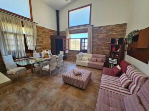 a living room with a couch and a table at Villa Mogaren in Vega de San Mateo