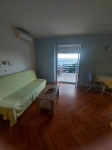 a bedroom with a bed and a table and a view of the ocean at Apartments Europa in Starigrad