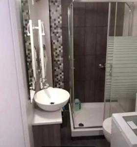 a bathroom with a sink and a shower and a toilet at Loutraki by the sea in Loutraki