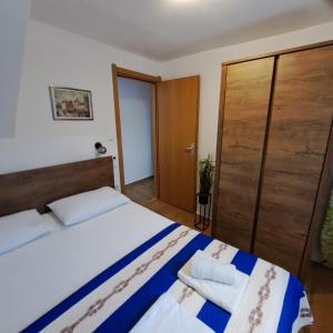 a bedroom with a bed with two towels on it at Kuća Get in Betina
