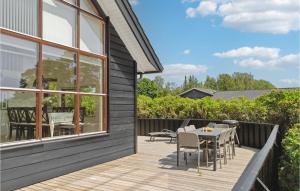 a wooden deck with a table and chairs on a house at Three-Bedroom Holiday Home In Ebeltoft in Ebeltoft +27 photos