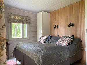 um quarto com uma cama grande e uma janela em Kodikas vapaa-ajan asunto Päijänteen rannalla em Sysmä