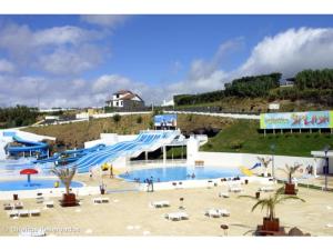 a large swimming pool with a slide at a resort at CASA Raiz in Ponta Delgada