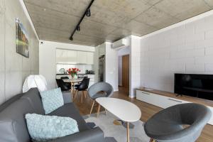 a living room with a couch and a table at River Side Residence nr3 in Oświęcim