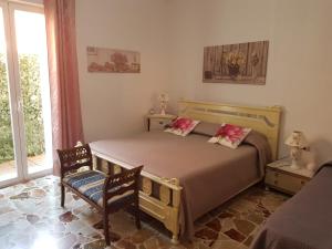 Postel nebo postele na pokoji v ubytování B&B CARRUBBELLE