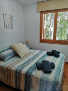 a bedroom with a bed with two pillows on it at Apartamento con piscina L' Áncora in Calella de Palafrugell