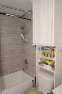 a bathroom with a tub and a toilet and a sink at Cottage by Jubilee in Freeport