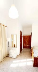 1 dormitorio con cama, tocador y espejo en Pefkos Filoxenia, en Pefki