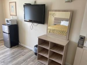 a room with a television and a bed and a tv at Coastal Inn - Ocean City in Ocean City