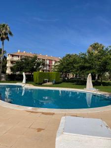 a large swimming pool in front of a building at Alcossebre, Apartamentos Hibiscus in Alcossebre