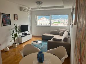 a living room with a couch and a table and chairs at Seaview Apartment Zetagradnja in Bar