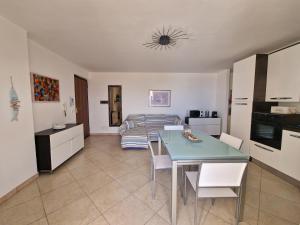 a kitchen and living room with a table and a couch at La Terrazza di Elisa in Marina di San Lorenzo