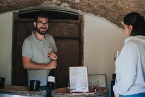 a man standing next to a table with wine glasses at Les Cabottes in Change