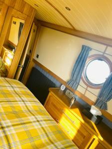 um quarto com uma cama e uma janela em Lovely 2-Bedroom Barge Brunswick Dock Liverpool! em Liverpool