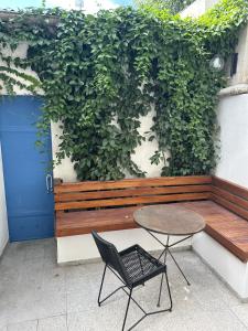 un banco de madera con una mesa y una silla en CASI EN CASA, en Lincoln