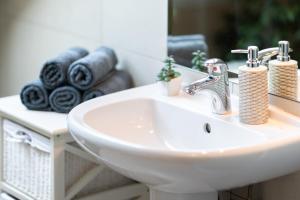 a bathroom sink with towels on a counter at Apartment Mia in Slunj +32 photos