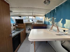 an rv with a kitchen and a table in it at !!Boat with AC in Port Forum 2 Bikes Included!! in Barcelona