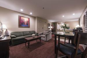 a living room with a couch and a table at Grand Vista Hotel in Simi Valley