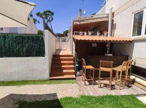 a patio with chairs and a table in front of a house at Chelor in Castelldefels