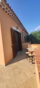 a patio of a house with a table and chairs at Petranova Affittacamere B&b in Agropoli