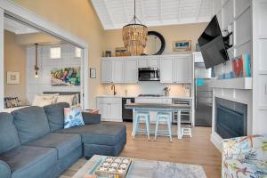 a living room with a couch and a kitchen at Quiet coastal home w gorgeous patio, steps from beach in Port Aransas