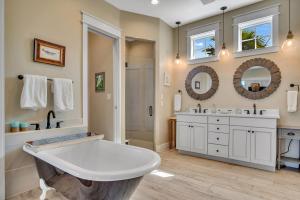 a large bathroom with a tub and a shower at Quiet coastal home w gorgeous patio, steps from beach in Port Aransas