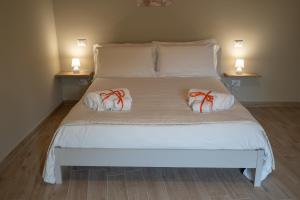 a large white bed with two pillows on it at Casa Sautu-fau in Santa Venerina +49 photos